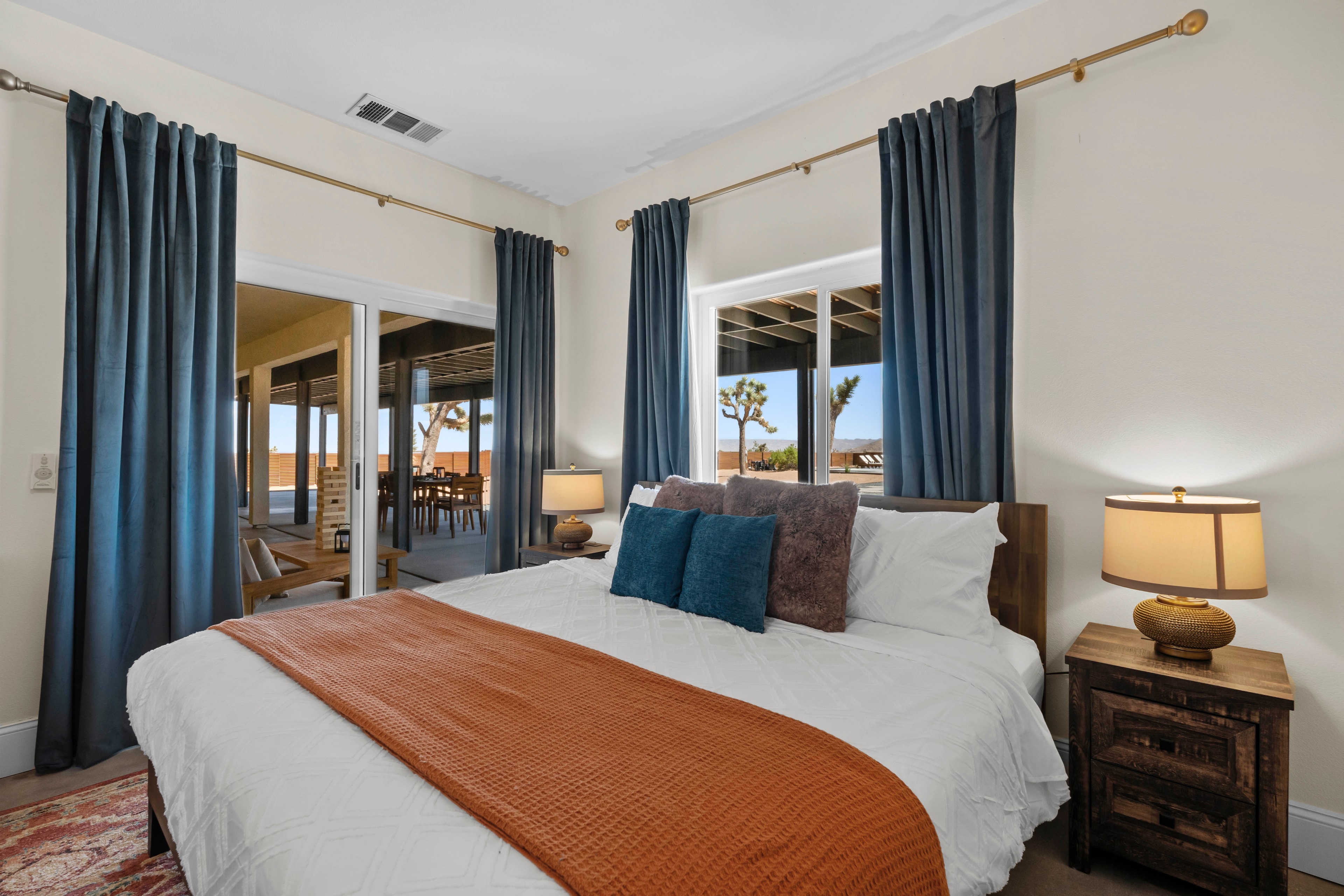 Primary suite with king bed and blue drapes at Waning Moon Ranch